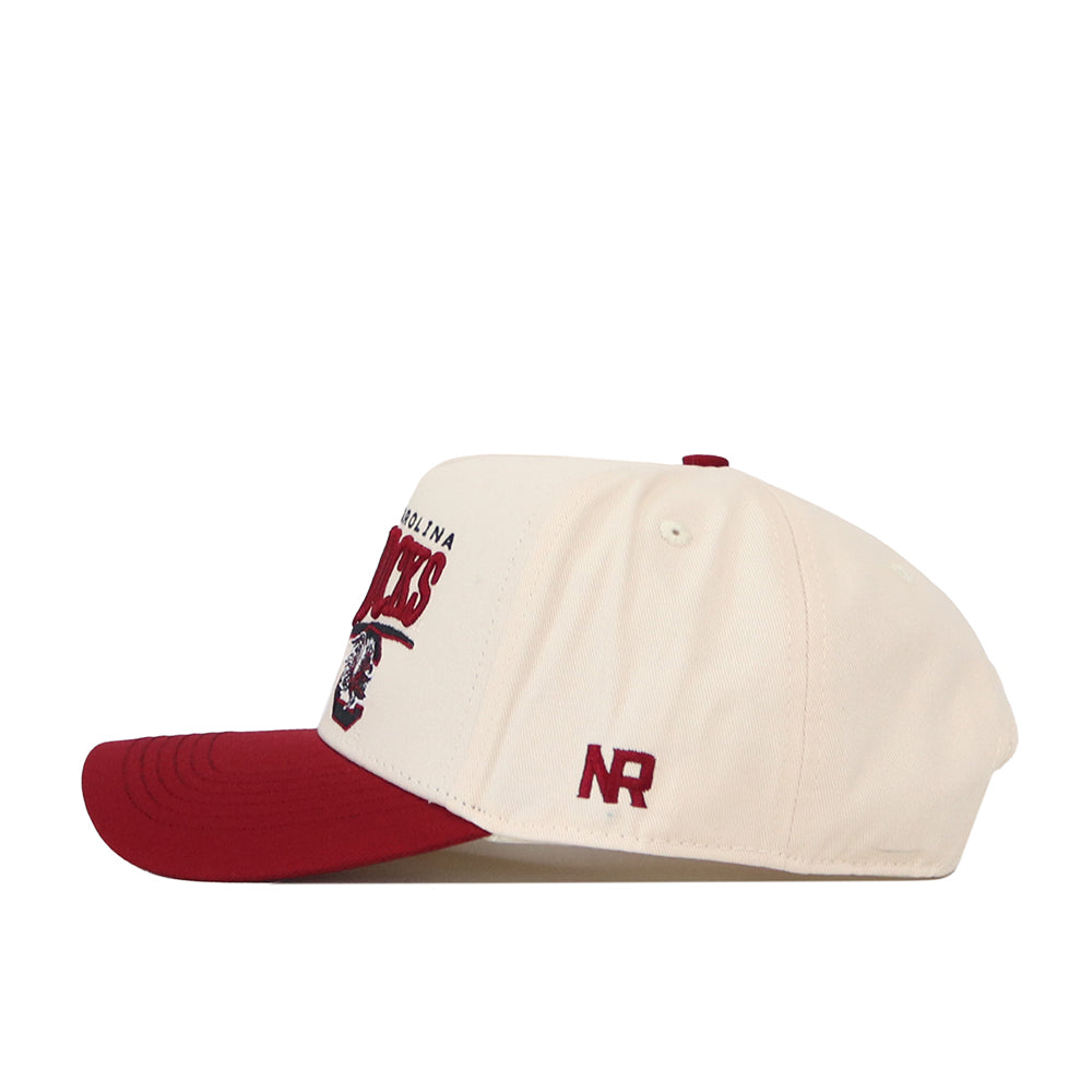 The South Carolina Gamecocks Stride Hat by No Rivals is a cream-colored baseball cap with a maroon brim and button, featuring an embroidered NR on the side. Made from high-quality cotton with a structured fit, this snapback showcases the South Carolina Gamecocks logo and text prominently on the front.
