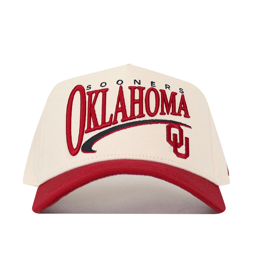 The No Rivals Oklahoma Sooners Stride Hat is a cream and red baseball cap featuring “SOONERS OKLAHOMA” and the OU logo in red on the front, designed with a structured fit and made from comfortable cotton material.