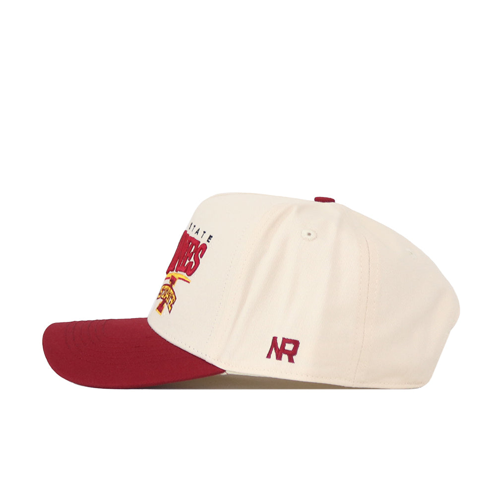The Iowa State Cyclones Stride Hat by No Rivals is a cream snapback baseball cap featuring a maroon bill. The side showcases an NR logo embroidered in maroon, while the front partially displays a maroon and gold design. Stylish embroidered logos throughout make it the perfect finishing touch for your gameday fit.
