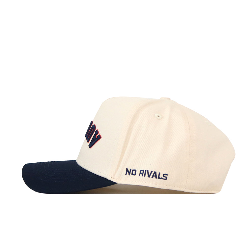 The No Rivals Auburn Tigers | Upside Down Auburn Hat - Classic Colors is a cream-colored snapback baseball cap with a navy brim. Embroidered in dark blue on the side is the “NO RIVALS” text, adding a bold and distinctive touch.