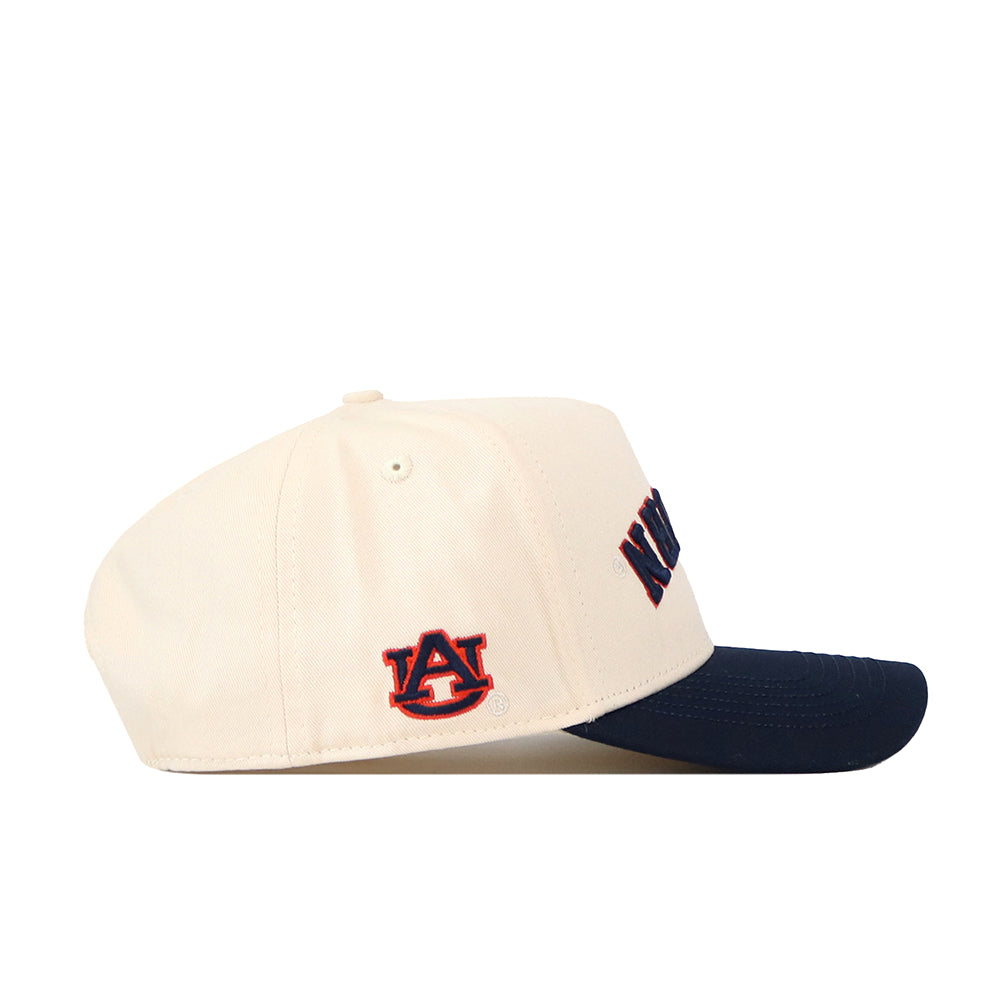 Show your spirit with the No Rivals Auburn Tigers | Upside Down Auburn Hat - Classic Colors. This cream-colored snapback features a navy blue brim and showcases the iconic Auburn University AU logo in orange and navy, embroidered on the side. Combining classic style and comfort, it’s a must-have for any dedicated fan.