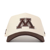 Introducing the No Rivals Minnesota Gophers Espresso Hat: This cream-colored baseball cap features a brown bill and showcases a prominent brown letter M outlined in white on the front. The classic snapback design is finished with an embroidered logo, adding extra detail and style.
