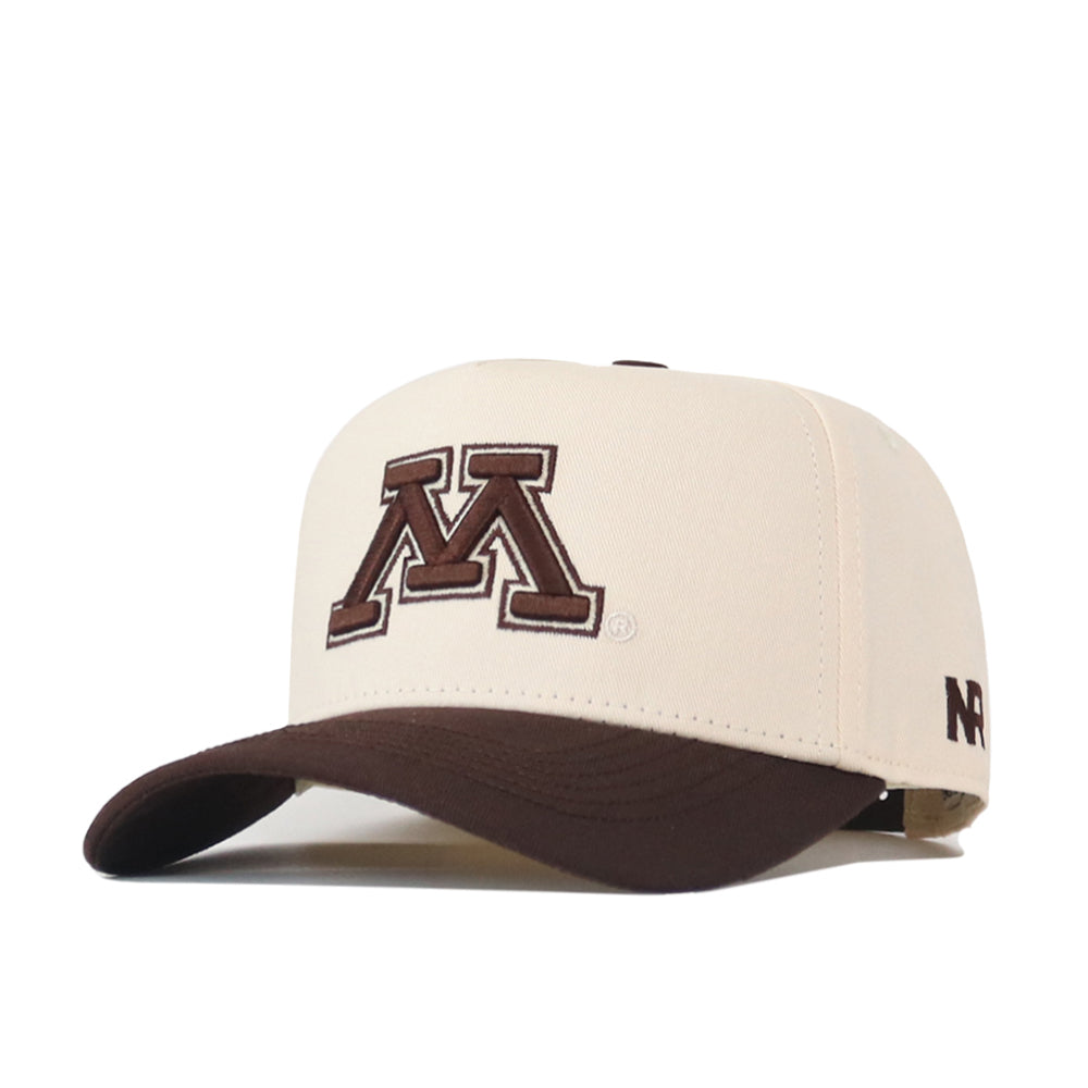 The Minnesota Gophers Espresso Hat by No Rivals is a beige snap back cap with a dark brown brim, featuring an embroidered large brown “M” outlined in maroon on the front and “NR” stitched in brown on the side. This officially licensed hat combines quality craftsmanship with comfortable style.