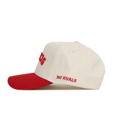 The Upside Down Scheels Hat is a cream cotton baseball cap with a red brim, featuring "NO RIVALS" embroidered in red on the side and an adjustable snapback closure for a perfect fit.