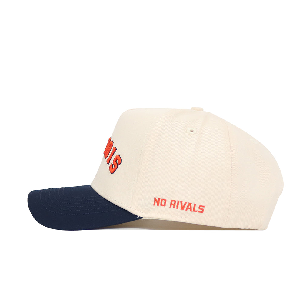 The Right Side Up Illinois Hat by No Rivals is a cream snapback with a navy brim, made from high-quality cotton and featuring bold red NO RIVALS embroidery on the side for standout style and a structured fit.