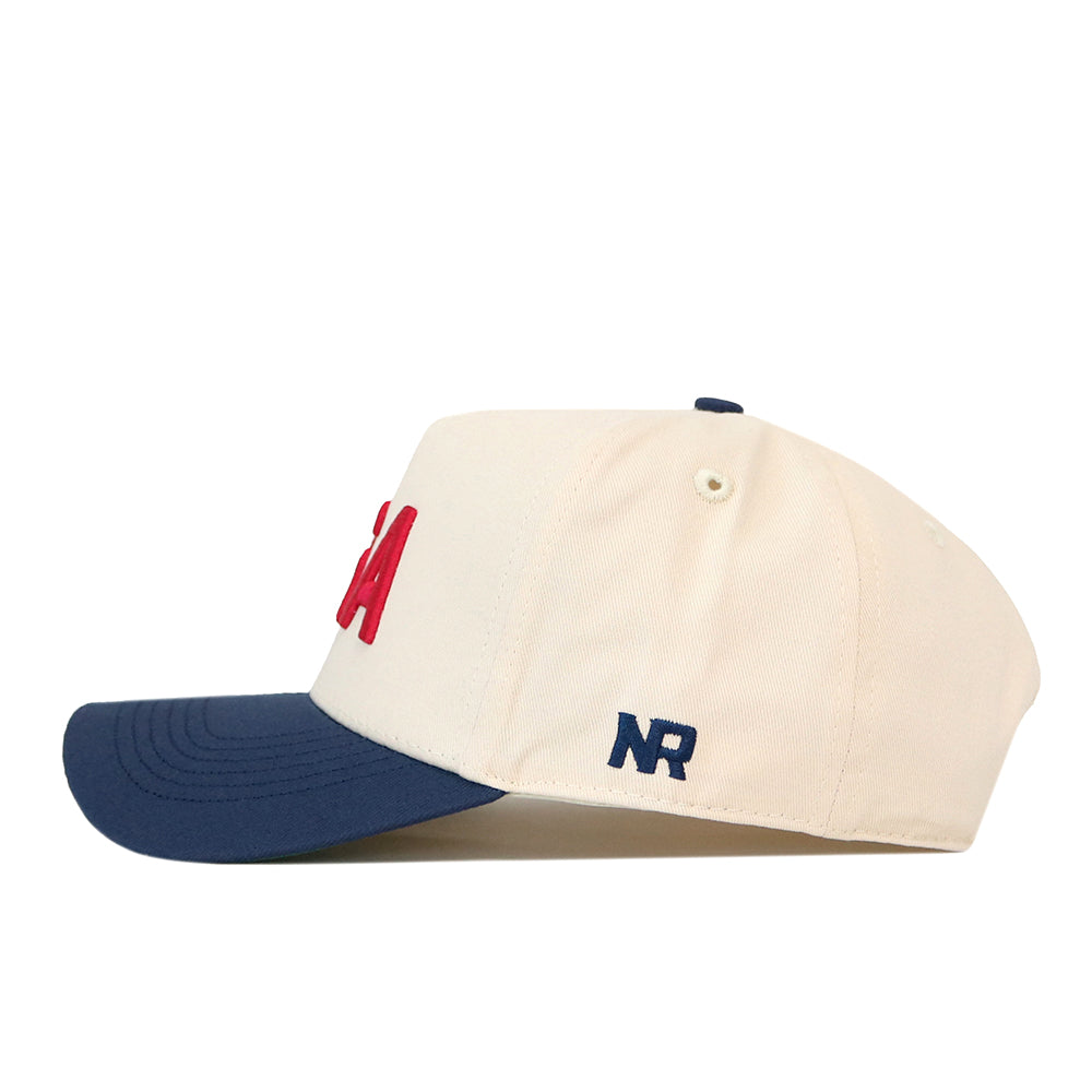 Off-white USA Vintage Hat - 5 Panel Structured with a navy blue snap back brim, red USA lettering on the front, and a navy blue NR logo on the side.