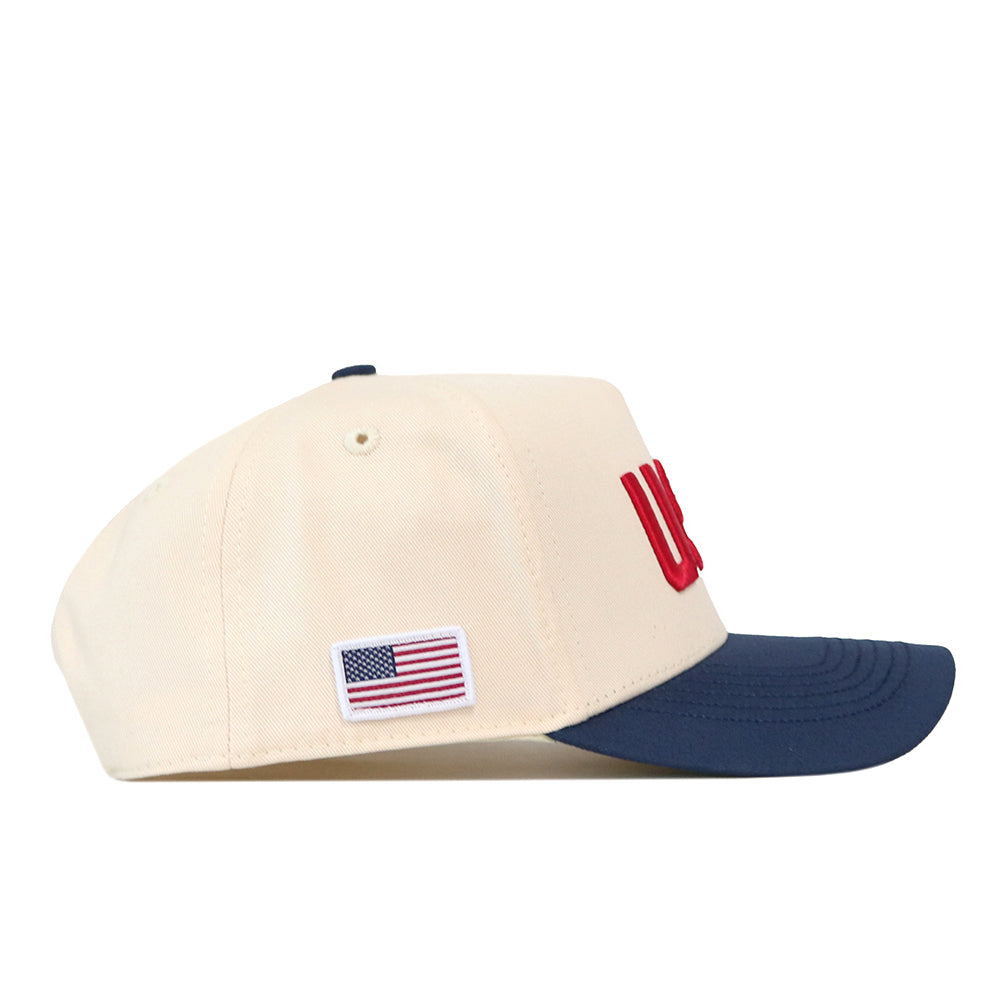 No Rivals USA Vintage Hat - 5 Panel Structured in off-white with a navy blue brim, featuring red embroidered graphics and a small American flag patch on the side.