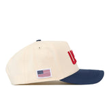 No Rivals USA Vintage Hat - 5 Panel Structured in off-white with a navy blue brim, featuring red embroidered graphics and a small American flag patch on the side.