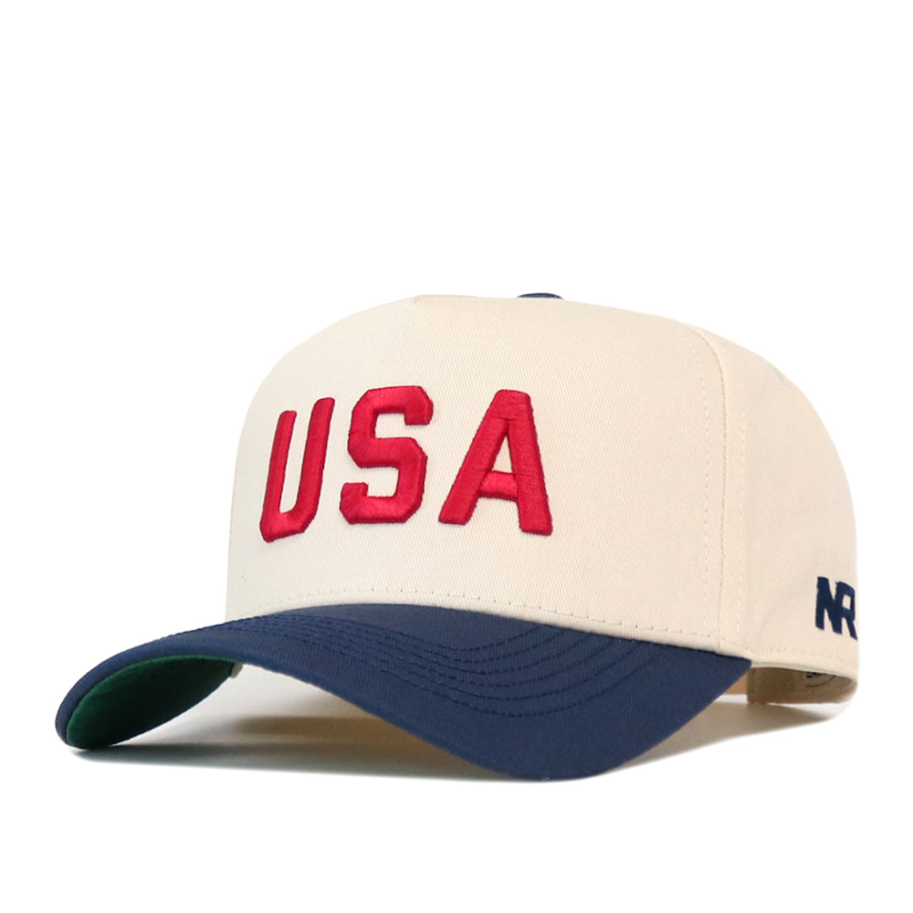 Off-white USA Vintage Hat - 5 Panel Structured featuring red embroidered USA lettering and a navy blue brim.