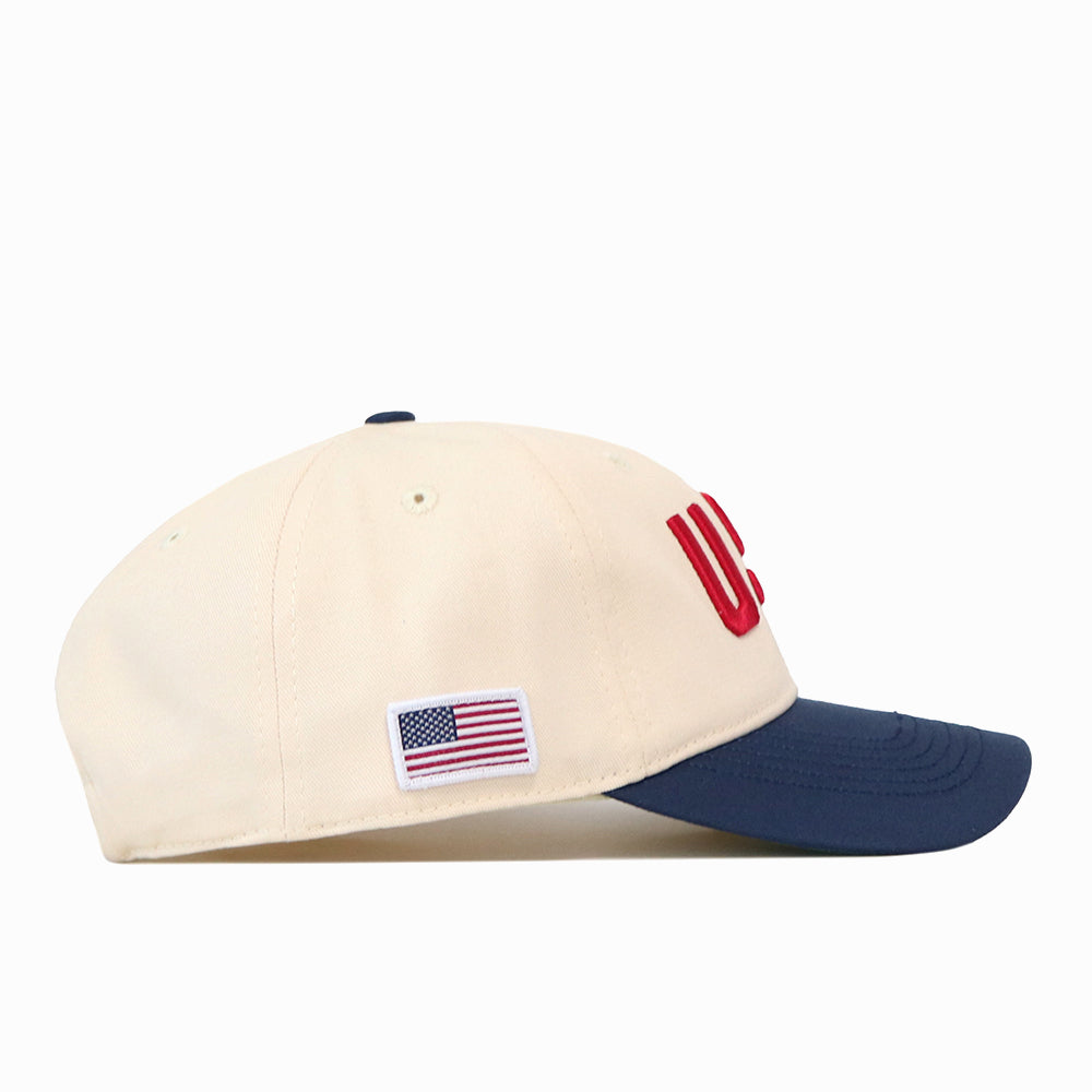 No Rivals USA Vintage Hat - 6 Panel Unstructured in off-white, featuring an unstructured 6-panel design with a navy blue brim, red embroidered USA on the front, and a small American flag patch on the side.