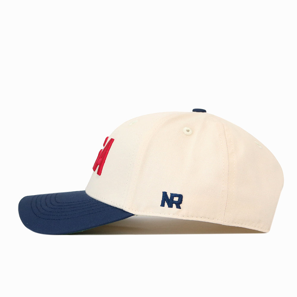 USA Vintage Hat - 6 Panel Structured in cream cotton with a blue brim, red front lettering, and blue NR embroidery on the side.