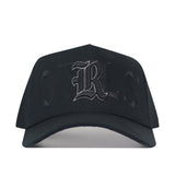 Rice Night Mode Hat: black snapback featuring an embroidered gothic-style letter R on the front in a blackout colorway.