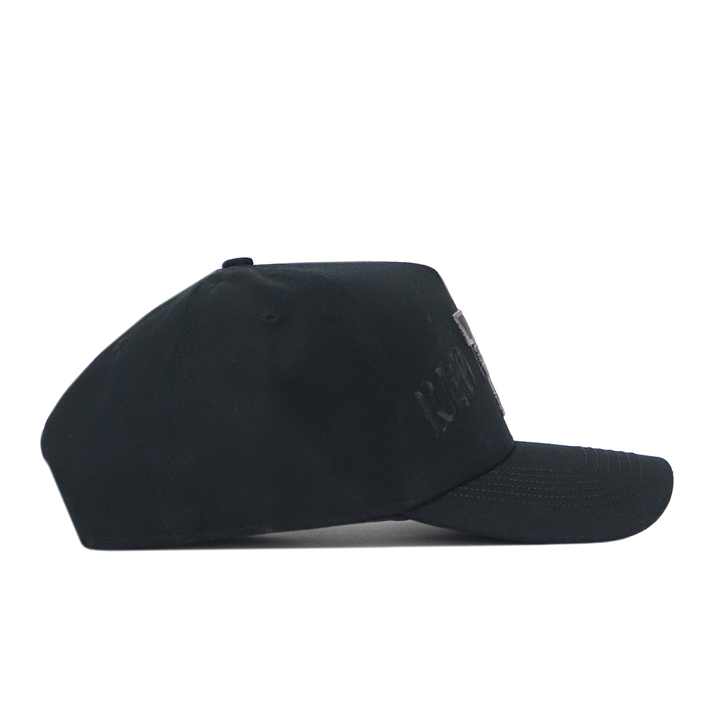 Side view of the Texas Tech Night Mode Hat, a blackout snapback featuring a dark embroidered patch logo on the front panel.