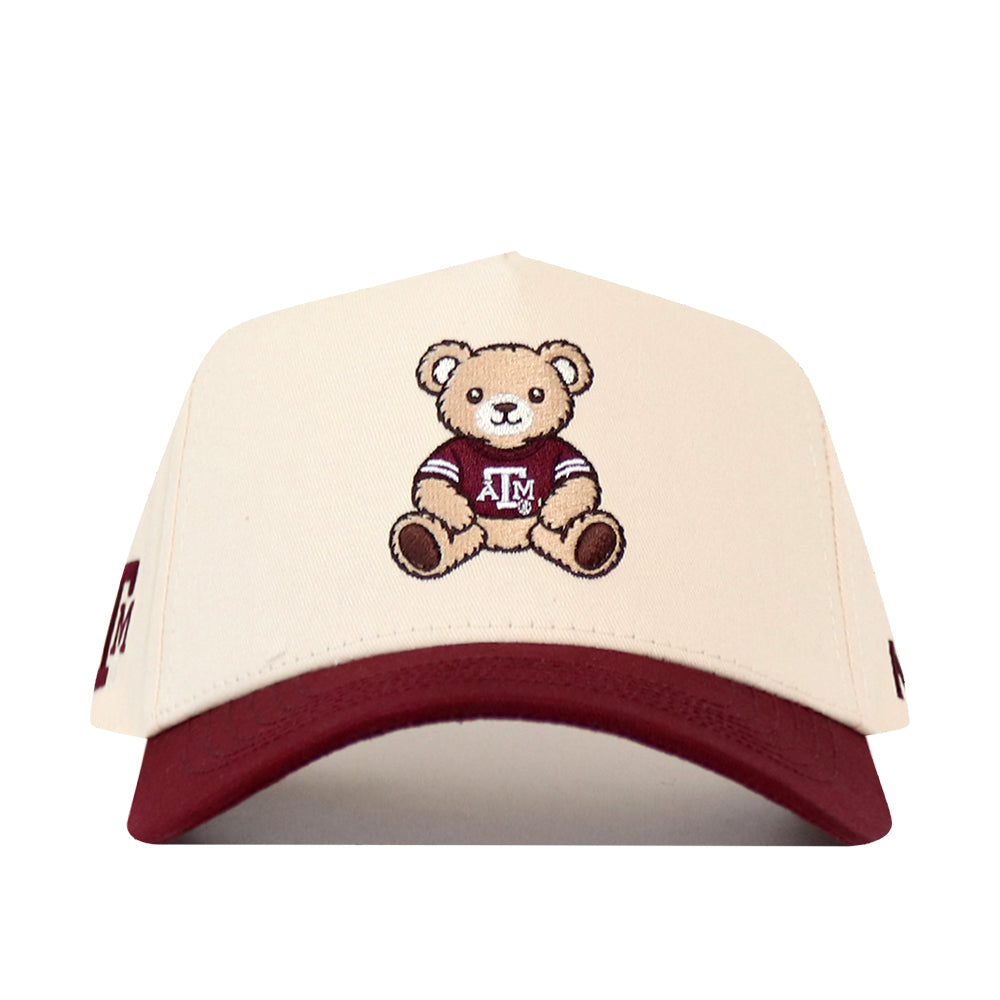 Cream-colored No Rivals Texas A&M Bear Hat - 5 Panel Structured with a maroon brim, featuring an embroidered teddy bear in a maroon Texas A&M logo shirt.