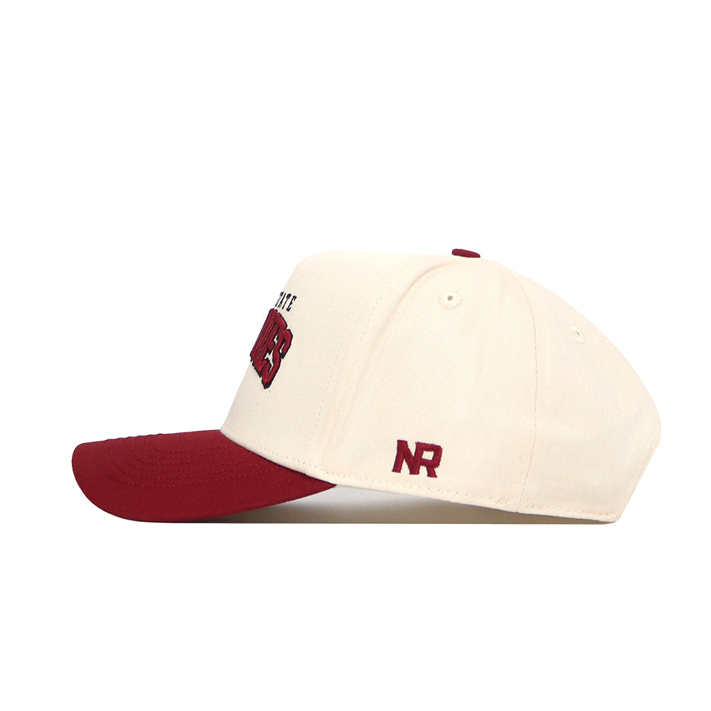 The No Rivals Iowa State Arch Hat is a cream cotton snapback with a red brim and button, red embroidered front text, and NR lettering on the side. Shown from the side on a white background.