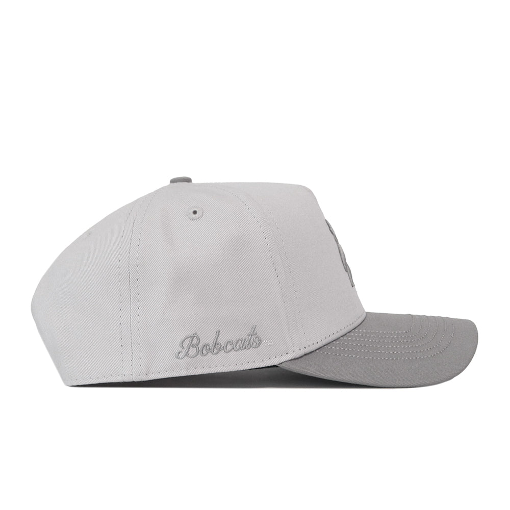 Texas State Graphite Hat, a light gray premium structured baseball cap with a dark gray brim, Bobcats embroidered on the side, and a snapback closure.