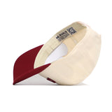 The No Rivals Iowa State Arch Hat is a cream-colored snapback with a maroon brim, shown from the side and underneath to highlight its inside label, adjustable strap, and high-quality cotton construction.