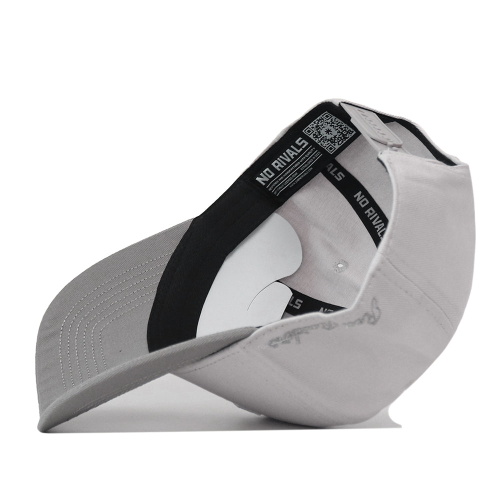 Side view of a light gray Texas Tech Graphite Hat showing the interior taping, curved brim, and snapback closure.