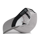 Side view of a light gray Texas Tech Graphite Hat showing the interior taping, curved brim, and snapback closure.