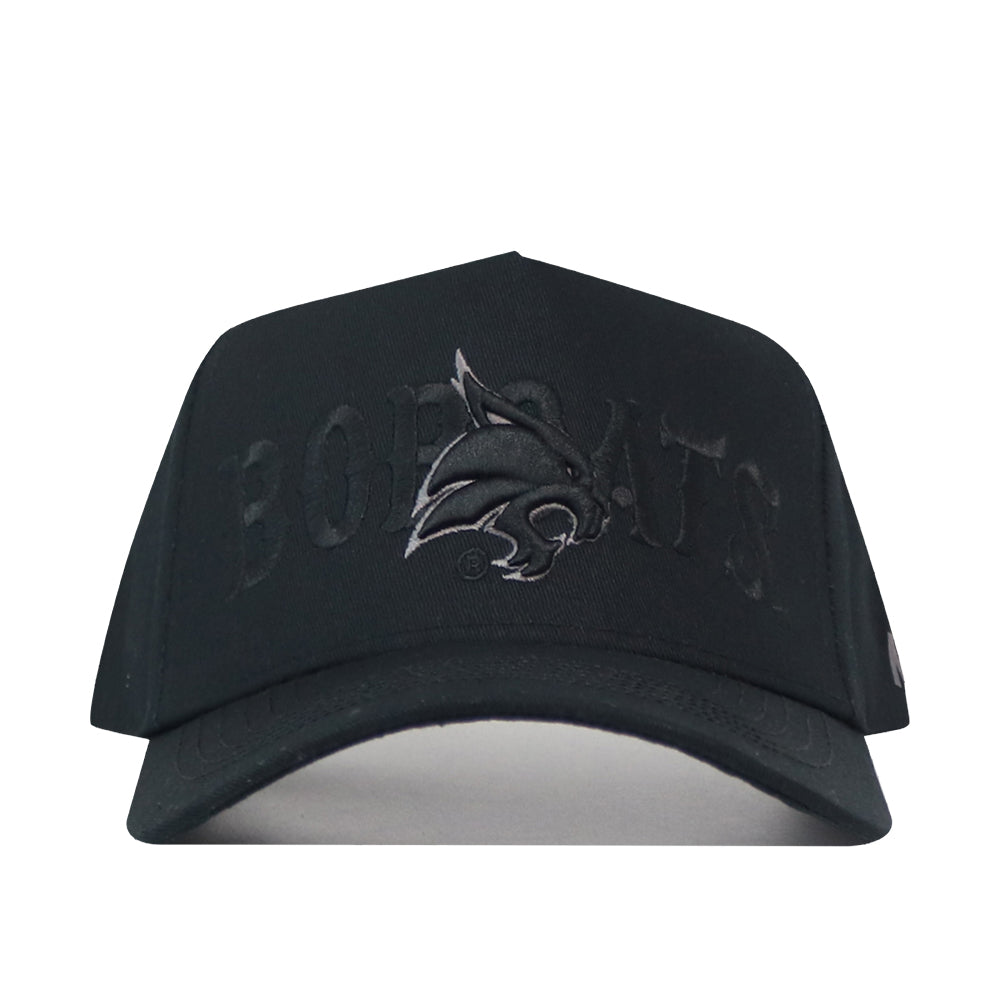 Texas State Night Mode Hat, a blackout baseball cap featuring an embroidered bobcat mascot logo and the word BOBCATS in tonal black stitching.