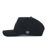 Side profile of a black Texas State Night Mode Hat featuring a tonal embroidered logo on the front and a small NR logo on the side.