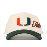 Cream-colored No Rivals Miami Halftime Hat featuring a green brim and an embroidered orange and green U logo on the front.