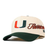 Off-white No Rivals Miami Halftime Hat with a green brim, featuring an orange and green University of Miami logo and the word Hurricanes embroidered in script on the side.