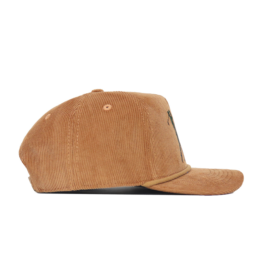 Side view of the No Rivals Early Tee Cord Hat in tan, a brown cotton corduroy snapback with a curved brim, textured fabric, ventilation eyelets, and subtle embroidered logos.
