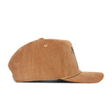 Side view of the No Rivals Early Tee Cord Hat in tan, a brown cotton corduroy snapback with a curved brim, textured fabric, ventilation eyelets, and subtle embroidered logos.