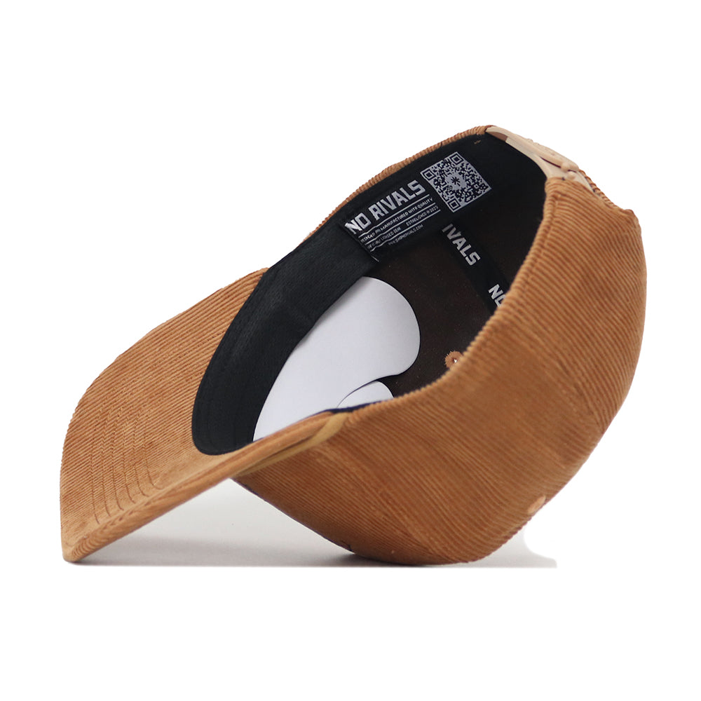 The Early Tee Cord Hat - Tan by No Rivals is shown upside down, displaying a black interior band with a No Rivals label, a QR code on the inside panel, and an adjustable snap back for a perfect fit.