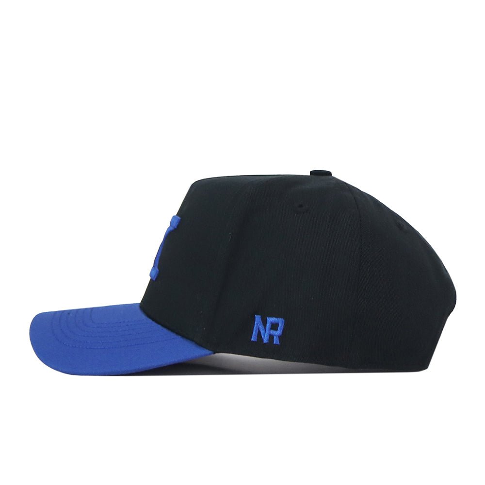 Here is your revised sentence using the provided product data: A black Kentucky Vintage K Hat by No Rivals featuring a blue brim, shown from the side. The initials NR are embroidered in blue on the left side above the brim, adding a bold touch to your perfect Gameday Fit.