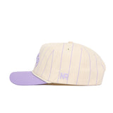The No Rivals ECU Powder Purple Pinstripe Hat features a cream snapback design with thin purple stripes, a lavender brim, and embroidered purple NR initials on the side. Made from high-quality cotton, shown in side profile against a white backdrop.