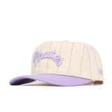 The No Rivals ECU Powder Purple Pinstripe Hat features a cream base, thin lavender pinstripes, curved lavender brim, and "Pirates" embroidered in lavender script on the front.