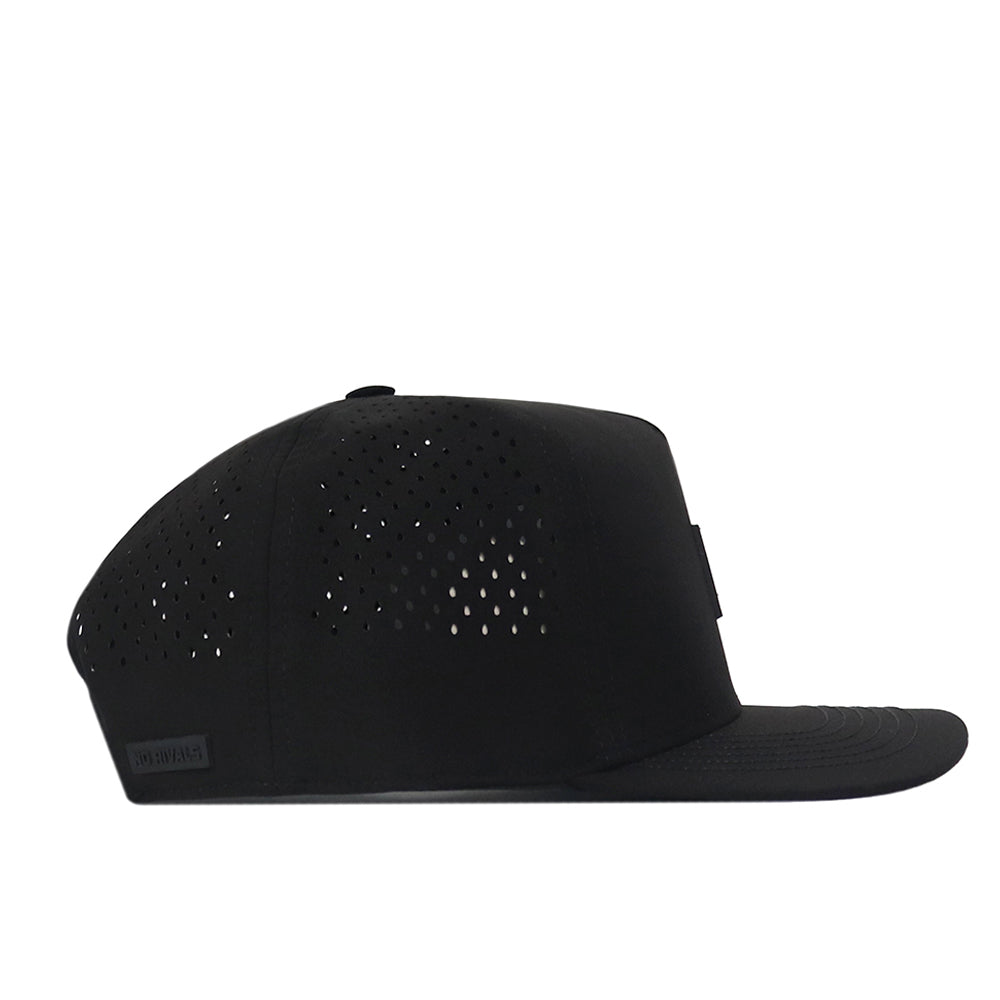 The No Rivals Michigan State Spartans Trainer Hat is a black snap back hat featuring a flat brim and small perforations on the side panels, crafted from high-quality cotton for durability and comfort. It is shown from the side on a white background.