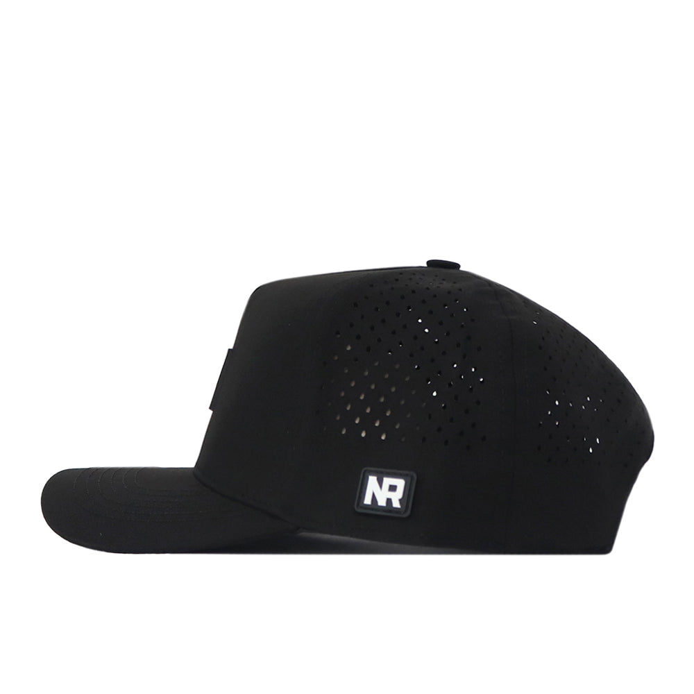 Side view of the black Boise State Broncos Trainer Hat by No Rivals, featuring small ventilation holes and a rectangular NR logo patch on the lower left side. This officially licensed cap offers a structured fit with a front panel and a curved brim.