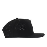 The No Rivals Boise State Broncos Trainer Hat is a black snapback cap with a flat brim and ventilated perforations on the side and back panels, offering a structured fit. Shown in profile view against a white background, this officially licensed hat combines style and comfort for fans.