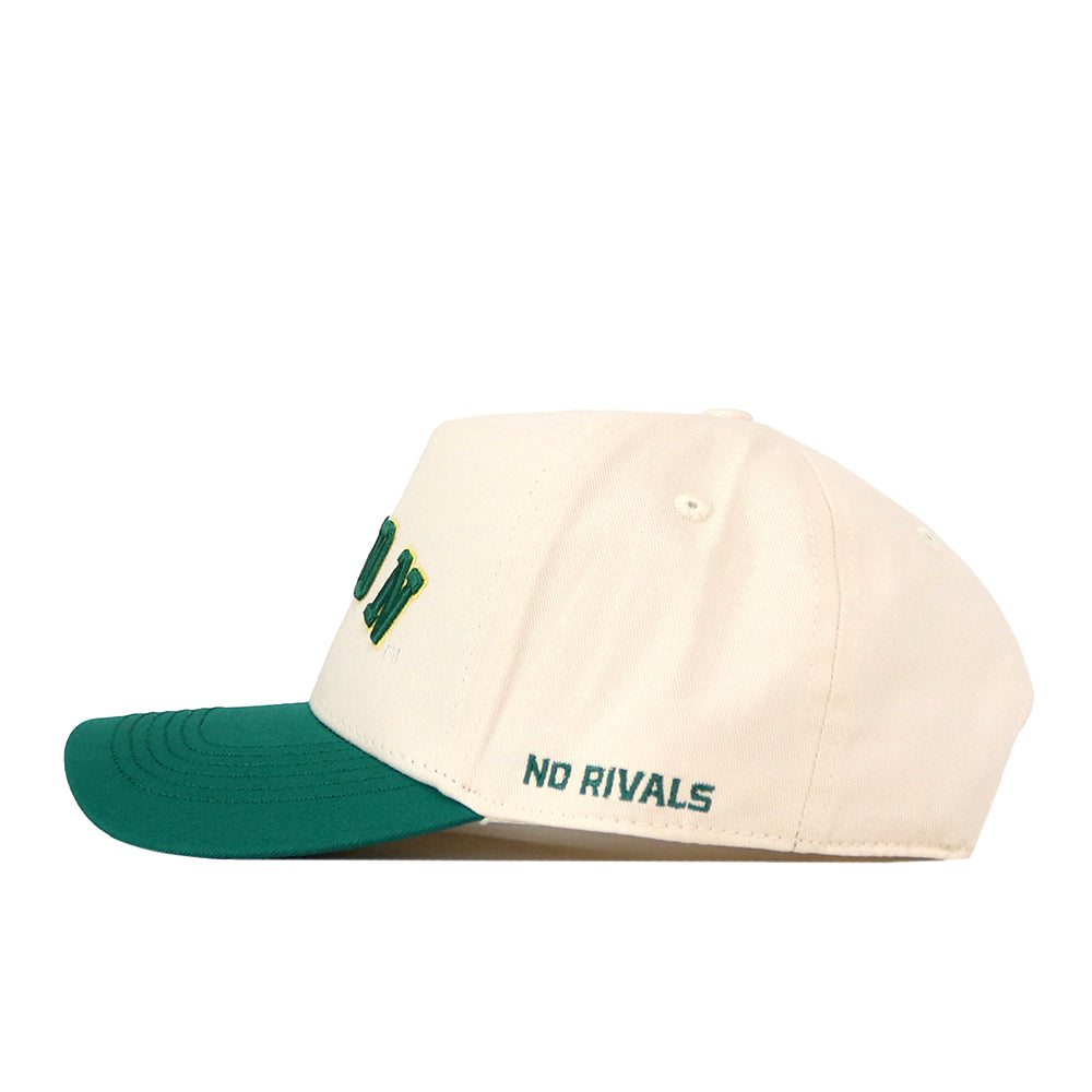 A cream-colored, snap back hat called the Right Side Up Bison Hat - Classic by No Rivals, featuring a green brim. The words “NO RIVALS” are embroidered in green above the ear, complemented by an embroidered logo for added style.