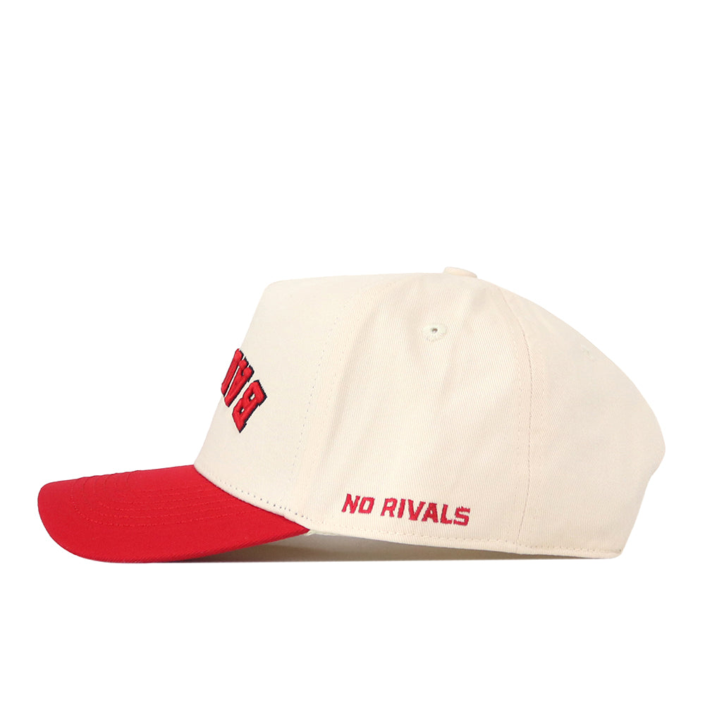 This snapback baseball cap, the Wisconsin Badgers Upside Down Badgers Hat - Classic by No Rivals, features a cream-colored crown with a red brim and partially visible red text on the front. The words “NO RIVALS” are embroidered in red on the side above the brim.