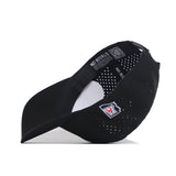 The No Rivals Arizona Golf Hat - Black is shown from the side and bottom, highlighting its structured fit, small ventilation holes, snapback adjustable strap, and a patch with a red, white, and blue shield logo on the side.