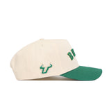 The No Rivals Right Side Up Bulls Hat - USF - Classic is a cream-colored, structured cotton cap with a green brim, an embroidered bull head logo on the side, and green front lettering.