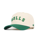 The Right Side Up Bulls Hat - USF - Classic by No Rivals is a cream baseball cap with green BULLS embroidery on the front, a green curved brim, and NR on the side. Made from premium cotton, this snapback combines comfort and style.