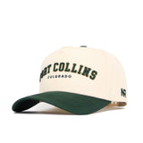 The Fort Collins Hometown Hat by No Rivals is a beige cotton cap with a dark green curved brim, featuring "FORT COLLINS COLORADO" in green and yellow embroidery and a small black N and R logo on the left side.