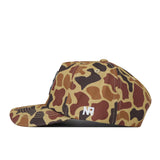 The No Rivals South Dakota State Huntsman Hat is a camouflage baseball cap featuring brown, tan, and dark green patterns. Made from high-quality cotton, it displays a white embroidered NP logo on the side. The hat is presented from a left side profile against a white background.