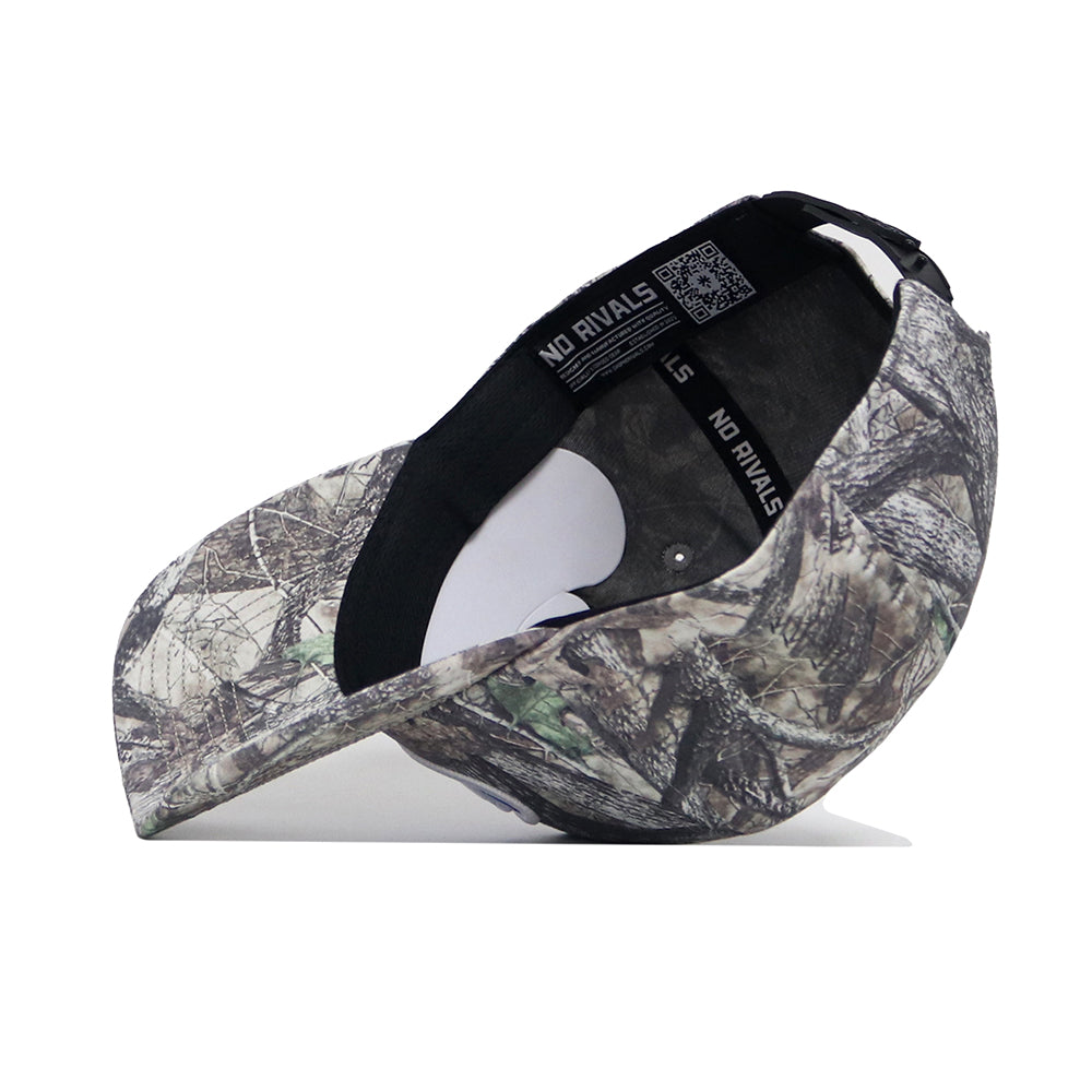 The No Rivals BYU Outland Hat is a snapback cap with a forest camo exterior, structured fit, adjustable strap, and interior black band that displays "NO RIVALS" text.