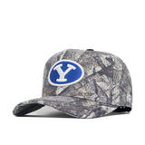 The BYU Outland Hat by No Rivals is a camouflage baseball cap with a blue oval patch and white Y on the front. Made from premium cotton, it features a structured fit, curved brim, and adjustable back strap.