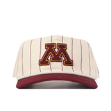 The No Rivals Minnesota Gopher Pinstripe Hat features a cream-colored design with thin maroon pinstripes, a bold maroon “M” outlined in gold embroidered on the front, and a matching maroon brim—making it the perfect addition to your next gameday fit.