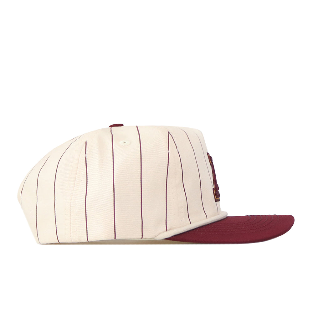 The Minnesota Gopher Pinstripe Hat by No Rivals features a cream-colored snapback design with thin vertical maroon stripes and a solid maroon brim, displayed from the left side against a white background—ideal for finishing off your gameday outfit.