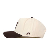 Introducing the Washington Huskies Espresso Hat by No Rivals—a cream-colored baseball cap with a brown brim, shown from the side. This classic snapback features a brown embroidered “NR” logo near the back and is perfect for polishing off your gameday look.