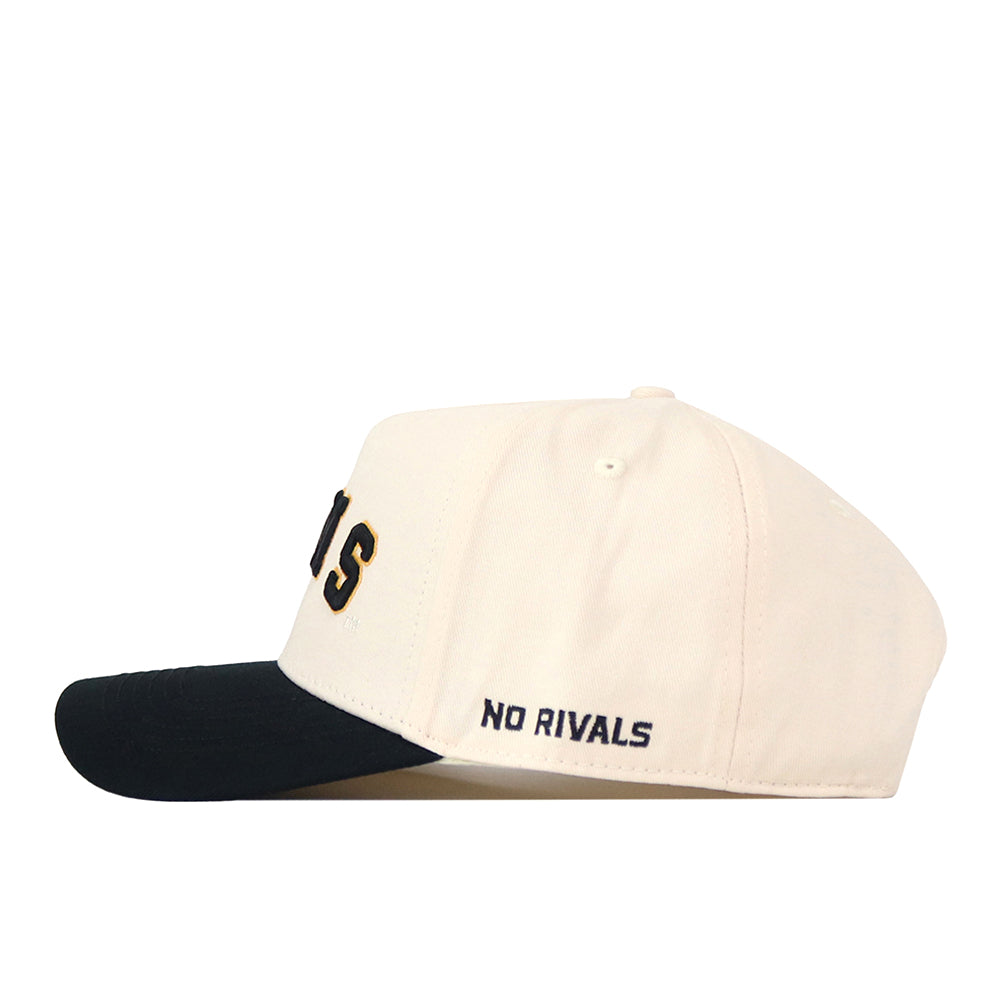Introducing the Right Side Up Rams Hat - VCU - Classic by No Rivals. This stylish snapback features a cream-colored crown, a contrasting black brim, and “NO RIVALS” embroidered in dark blue on the side. The front showcases a partially visible embroidered logo, making it the perfect accessory to complete your game day look.