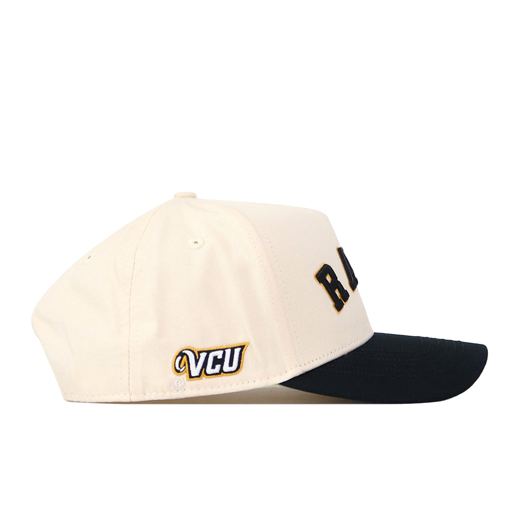 The No Rivals Right Side Up Rams Hat - VCU - Classic features a beige crown with a black brim. The letters “RA” are displayed on the side, and a small embroidered VCU logo is positioned near the back. With its classic snapback closure, this cap is the ideal choice for gameday style.